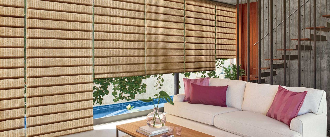 Living room with white couch and red pillows with Vignette Roman Shades.